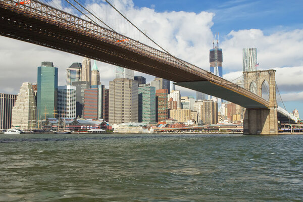 Brooklyn bridge and Lower Manhattan with Freedom Tower ( New York City ). Horizontally.