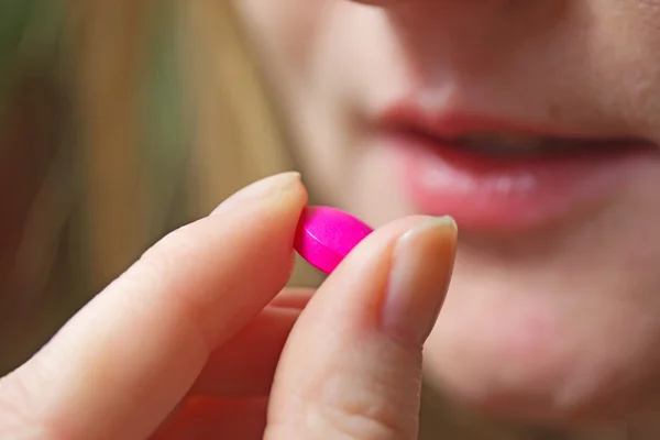 Young woman with pill — Stock Photo, Image