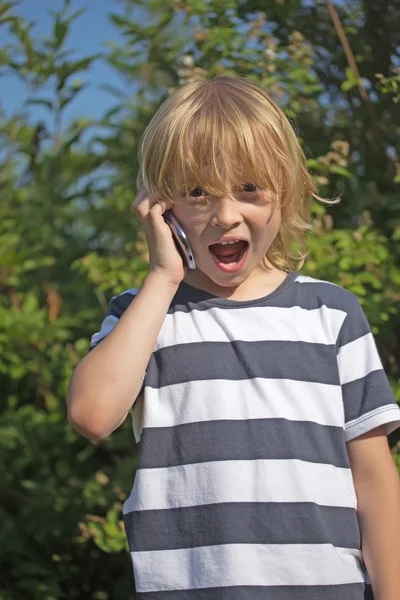 Atractive surpriced blond boy is calling — Stock Photo, Image