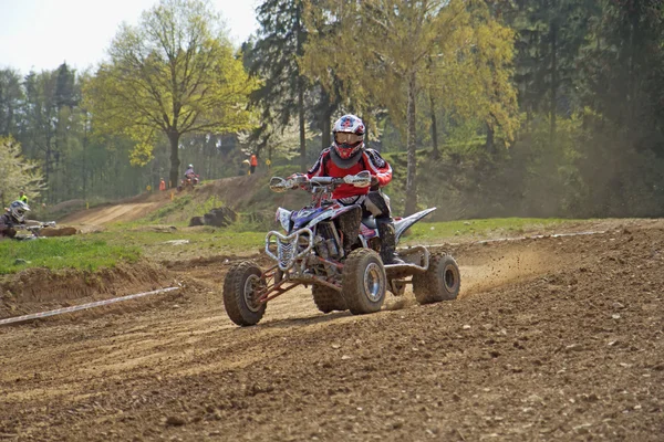 Young quad racer is passing sweep — Stock Photo, Image