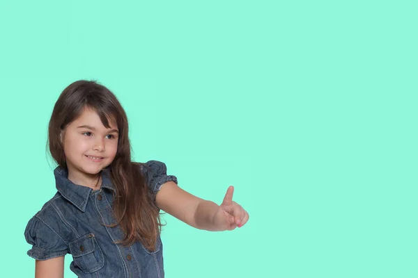 Smiling Tanned Long Haired Little Girl Wears Denim Costume Pointing — Stock Photo, Image
