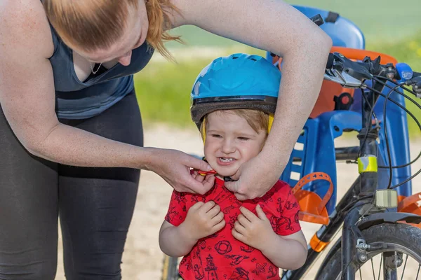 Mother Puts Bicycle Helmet Head Her Little Son Horizontally — Stock Photo, Image