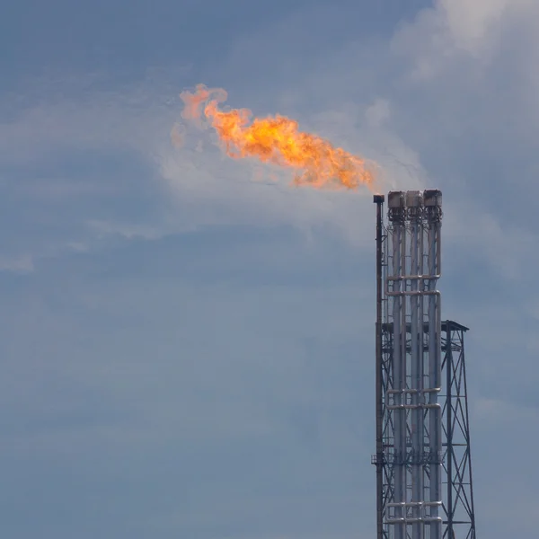 Burning oil gas flare during sunset — Stock Photo, Image