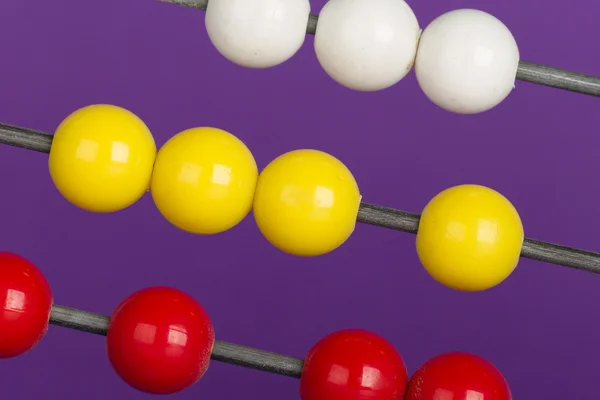 Close-up of an abacus on a purple background — Stock Photo, Image