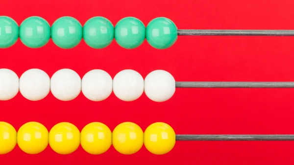 Close-up of an abacus on a red background — Stock Photo, Image
