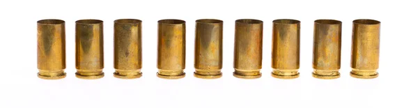 Empty 9mm bullet casings over white background — Stock Photo, Image