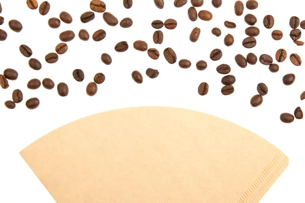 Coffee beans on a coffee filter (white background) — Stock Photo, Image