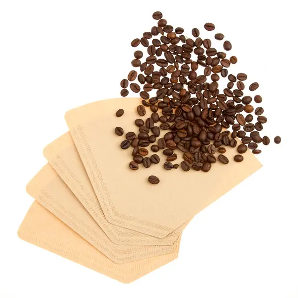 Coffee beans on a coffee filter (white background) — Stock Photo, Image