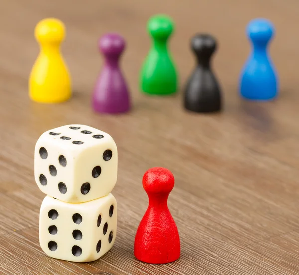 Six colored pawns and two dice — Stock Photo, Image