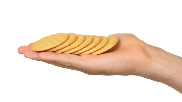Uomo con la mano piena di biscotti — Foto Stock
