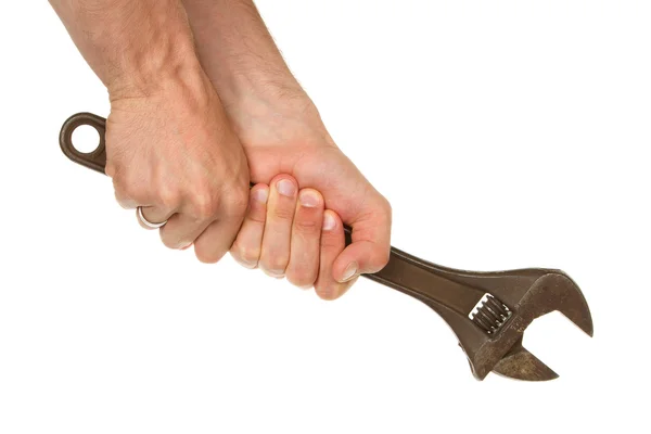 Old rusted adjustable wrench in a hand — Stockfoto