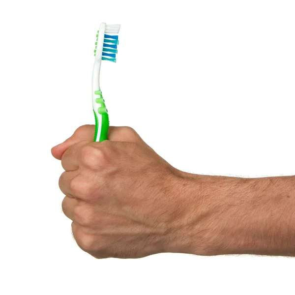 Homem segurando uma escova de dentes verde — Fotografia de Stock