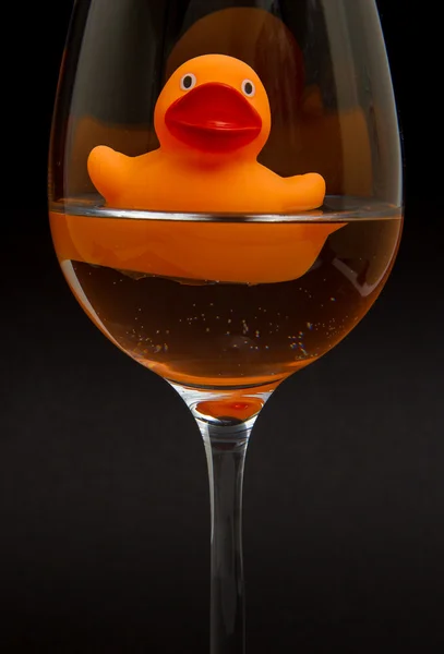 Pato de goma naranja en una copa de vino — Foto de Stock