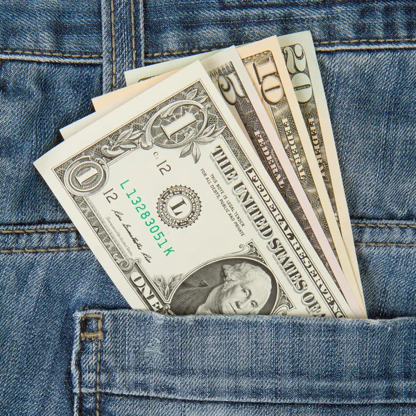 Macro shot of trendy jeans with american four different dollar b — Stock Photo, Image