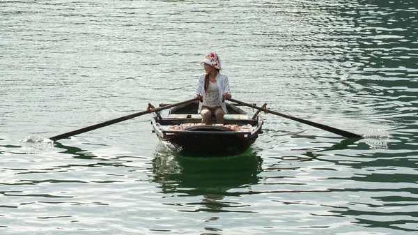 HA LONG BAY, VIETNAM AUG 10, 2012 - Продавец продуктов питания на лодке. Многие Vi — стоковое фото