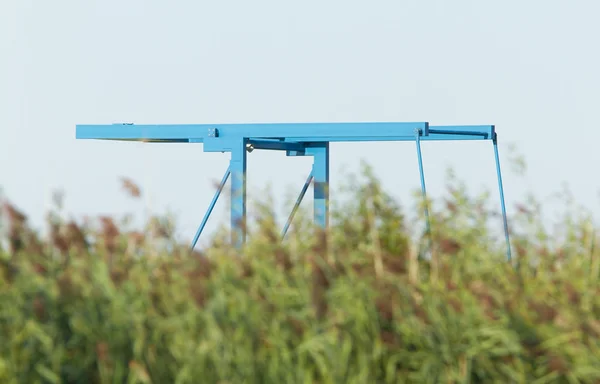 Blue drawbridge hidden in the reeds — Stock Photo, Image