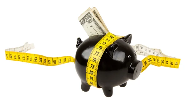 Black piggy bank with measuring tape — Stock Photo, Image