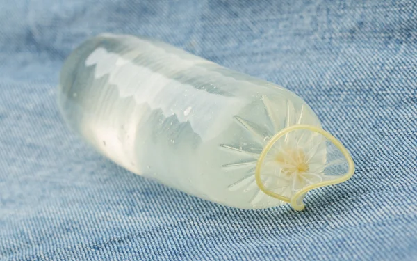 Condón lleno de agua en jeans — Foto de Stock