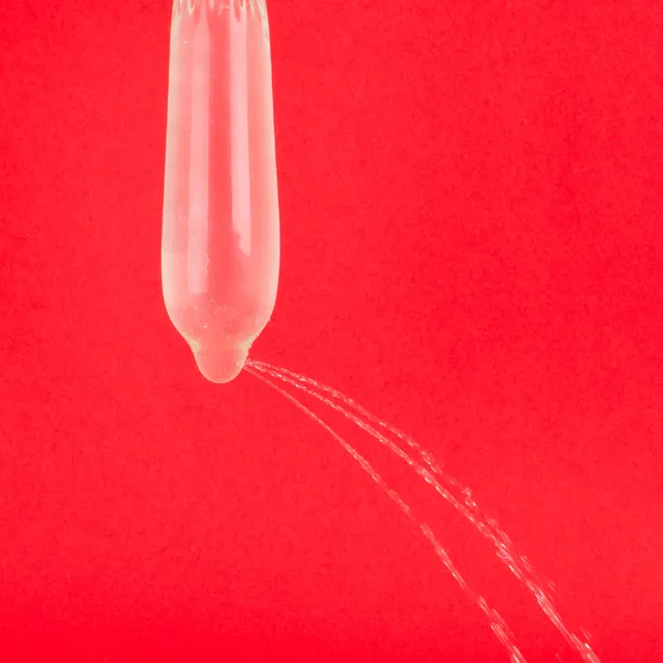 Condom with water but leaking — Stock Photo, Image