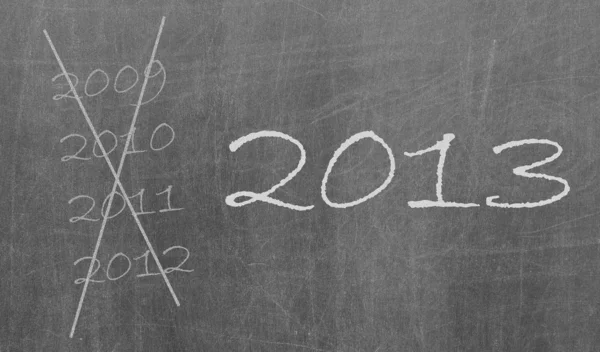 2009, 2010 e 2012 cruzado e ano novo 2013 escrito em chalkbo — Fotografia de Stock