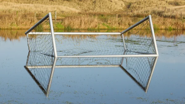 Fútbol gol en un campo inundado —  Fotos de Stock