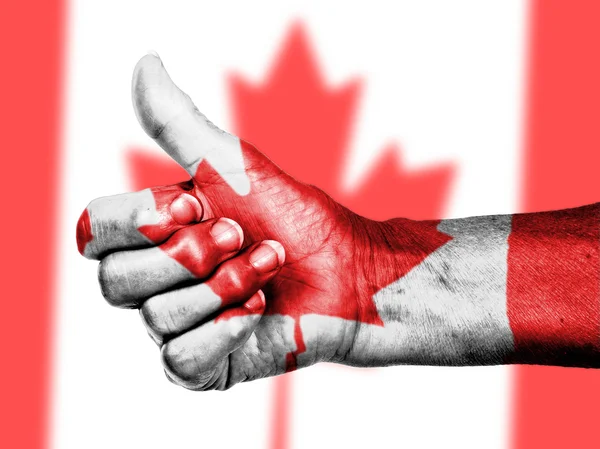 Canadian flag on thumbs up hand — Stock Photo, Image