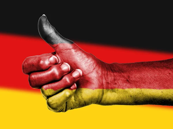 Německá vlajka na palce ruky — Stock fotografie