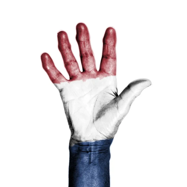 Hand van een oude vrouw, omwikkeld met een patroon van de vlag van holl — Stockfoto