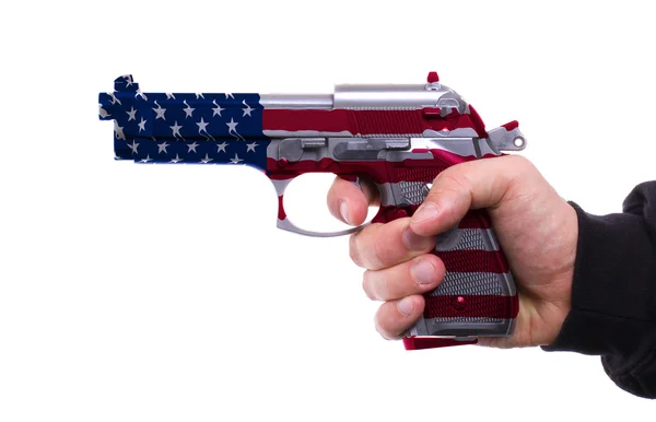 Pistola com padrão de bandeira dos EUA na mão — Fotografia de Stock