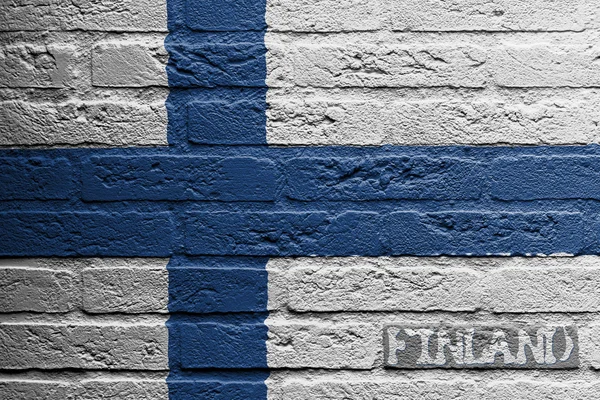 Bakstenen muur met een schilderij van een vlag, finland — Stockfoto