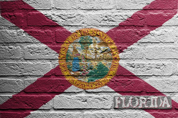 Parede de tijolo com uma pintura de uma bandeira, Flórida — Fotografia de Stock