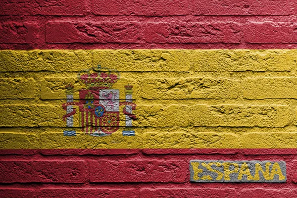 Pared de ladrillo con una pintura de una bandera —  Fotos de Stock