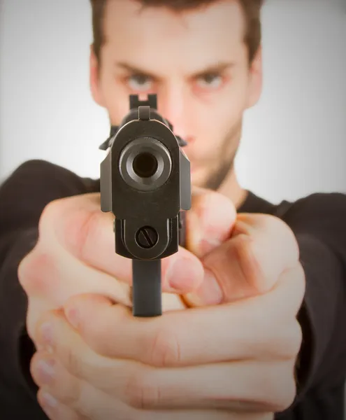 Man with a gun ready to shoot — Stock Photo, Image