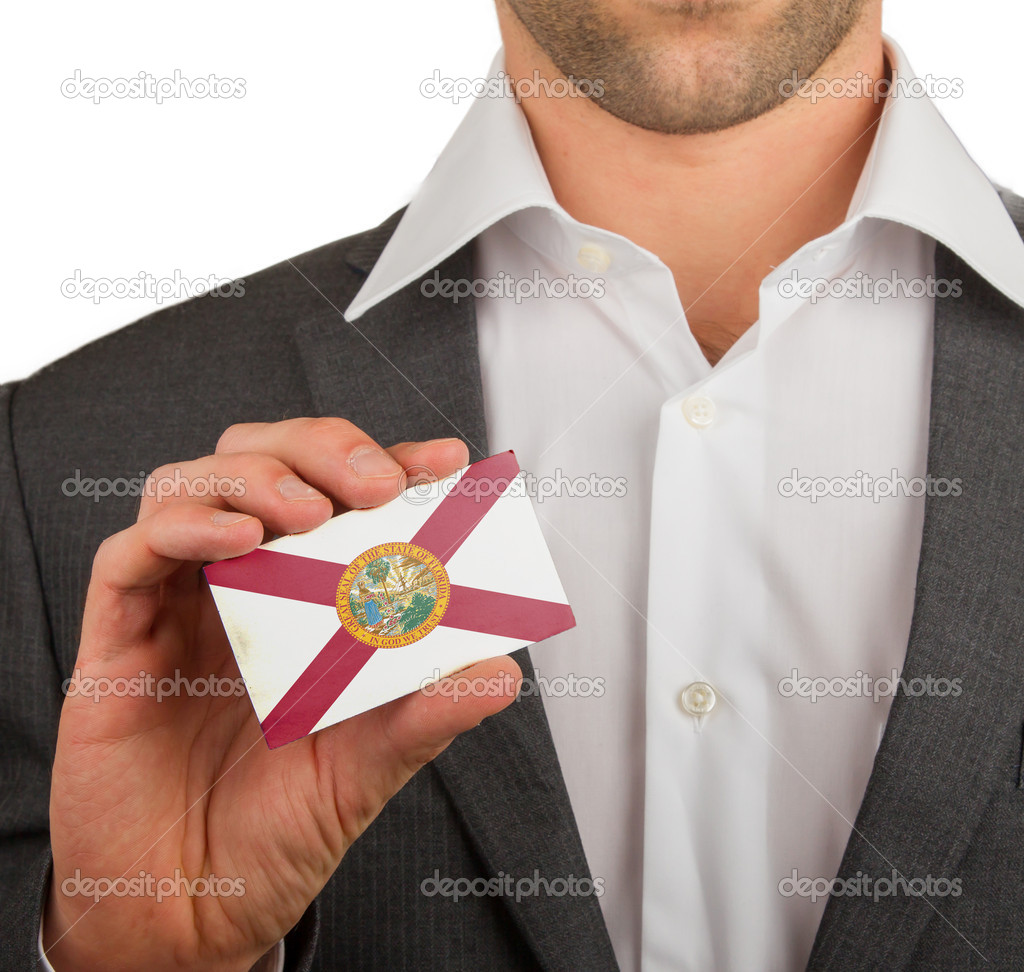 Businessman is holding a business card, flag of Florida