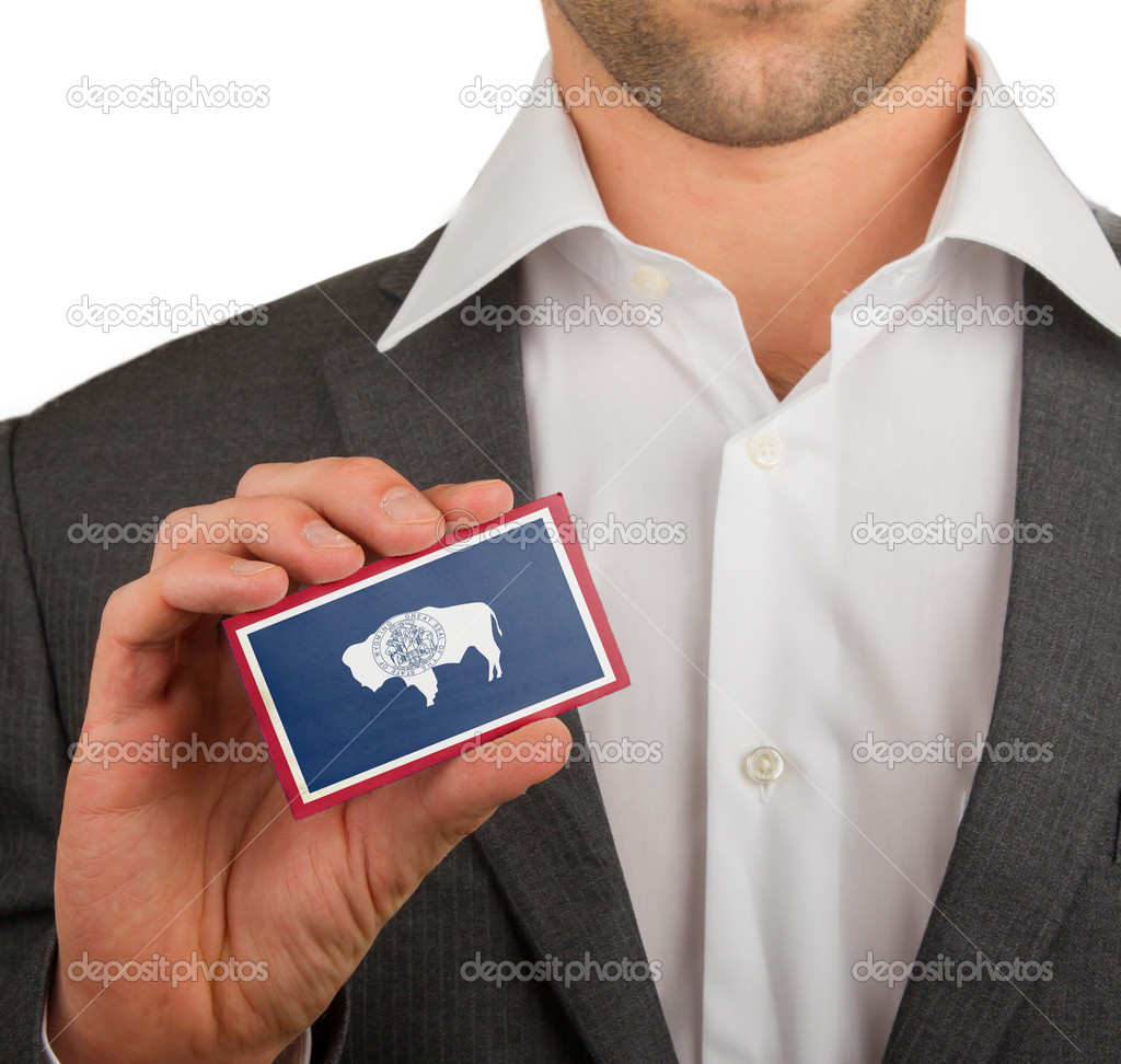 Businessman is holding a business card, flag of Wyoming