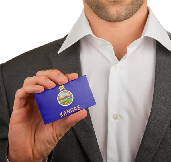 Businessman is holding a business card, Kansas — Stock Photo, Image