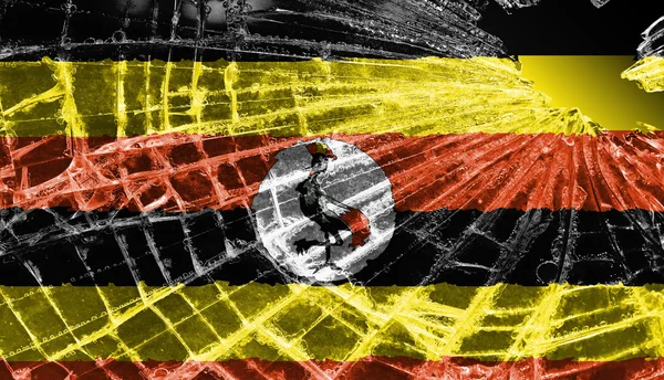 Trasiga is eller glas med en flagga mönster, uganda — Stockfoto