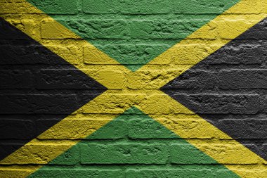 Brick wall with a painting of a flag, Jamaica