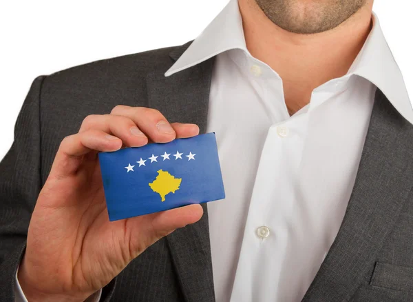 Businessman is holding a business card, Kosovo — Stock Photo, Image