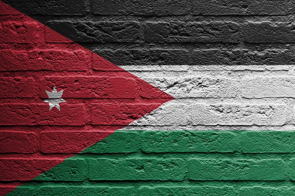 Pared de ladrillo con una pintura de una bandera, Jordania — Foto de Stock