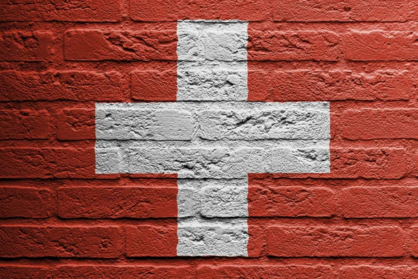 Bakstenen muur met een schilderij van een vlag, Zwitserland — Stockfoto