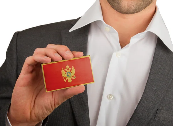 Businessman is holding a business card, Montenegro — Stock Photo, Image