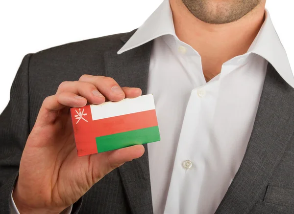 Businessman is holding a business card, Oman — Stock Photo, Image