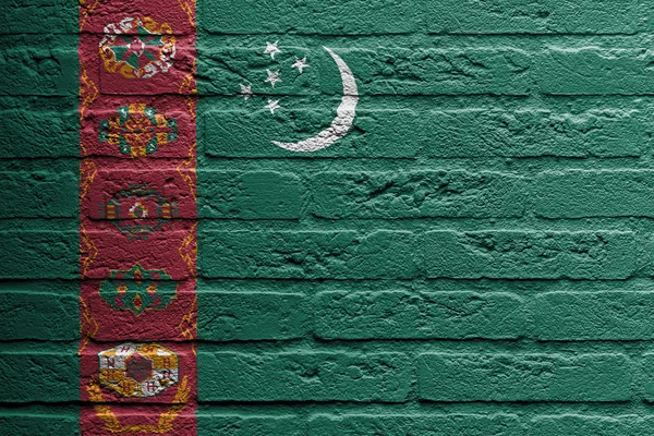 Muro de ladrillo con una pintura de una bandera, Turkmenistán —  Fotos de Stock