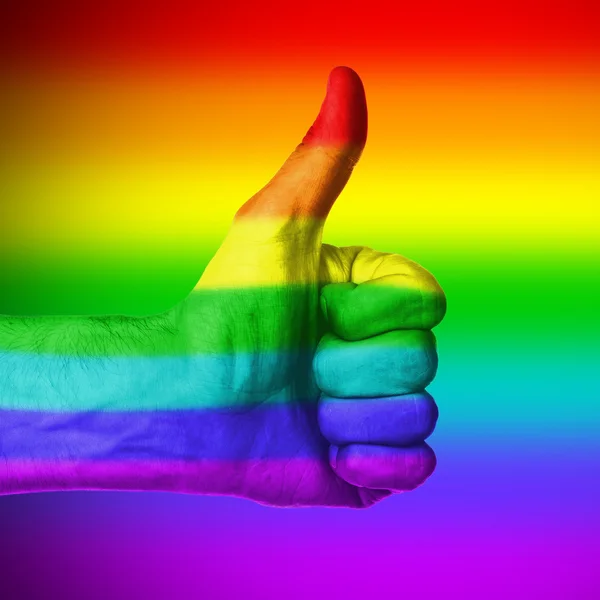 Image of a mans hand showing thumb up, rainbow flag — Stock Photo, Image