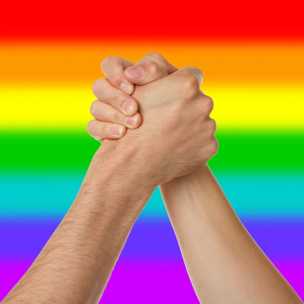 Man and woman in arm wrestlin, rainbow flag pattern — Stock Photo, Image