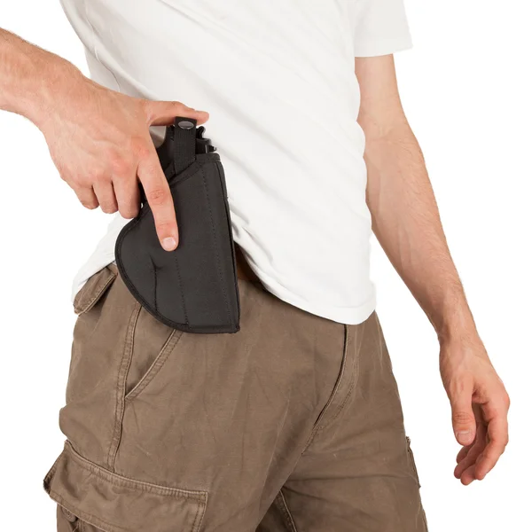 Close-up of a man with his hand on a gun — Stock Photo, Image