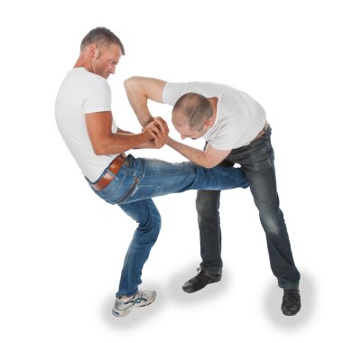 Man trying to kidnap another man, selfdefense, kicking in groin clipart