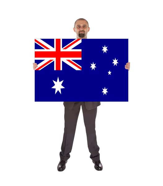 Büyük bir kart, Avustralya bayrağı tutarak gülümseyen iş adamı — Stok fotoğraf