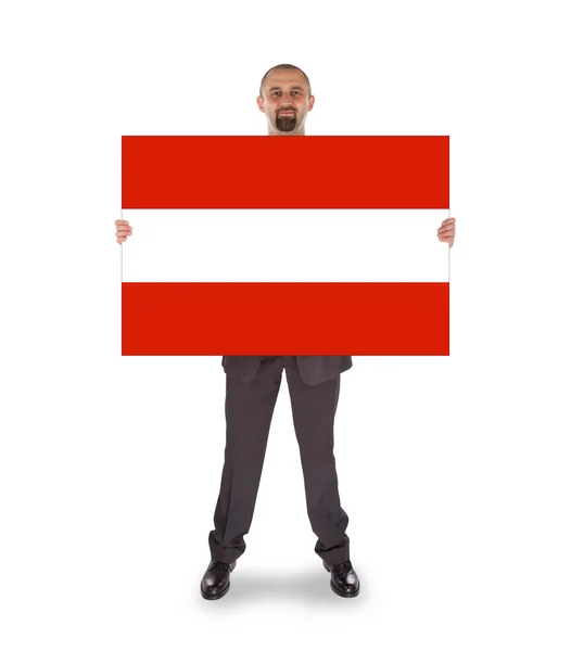 Smiling businessman holding a big card, flag of Austria — Stock Photo, Image